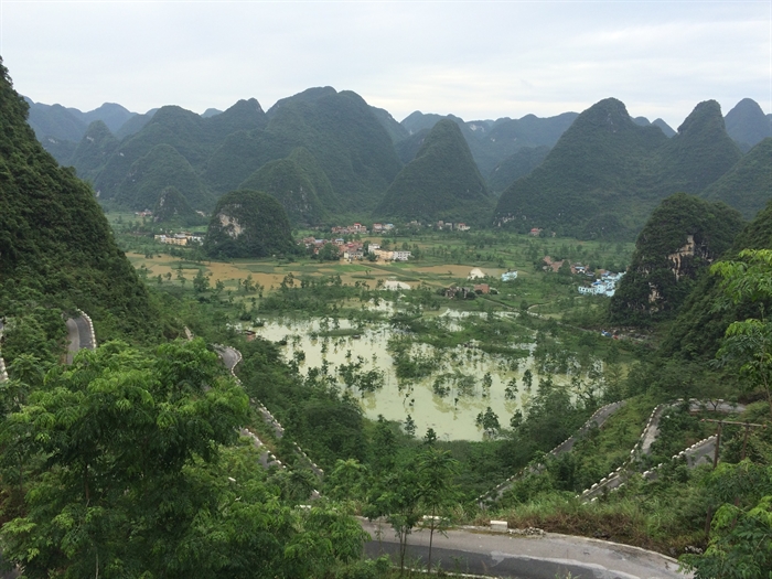 Groundwater flooding (clear water), exacerbated by overland flooding (muddy water), occurred across southwest China’s karst lowland in 2016. (Photograph by Yunpeng Nie)